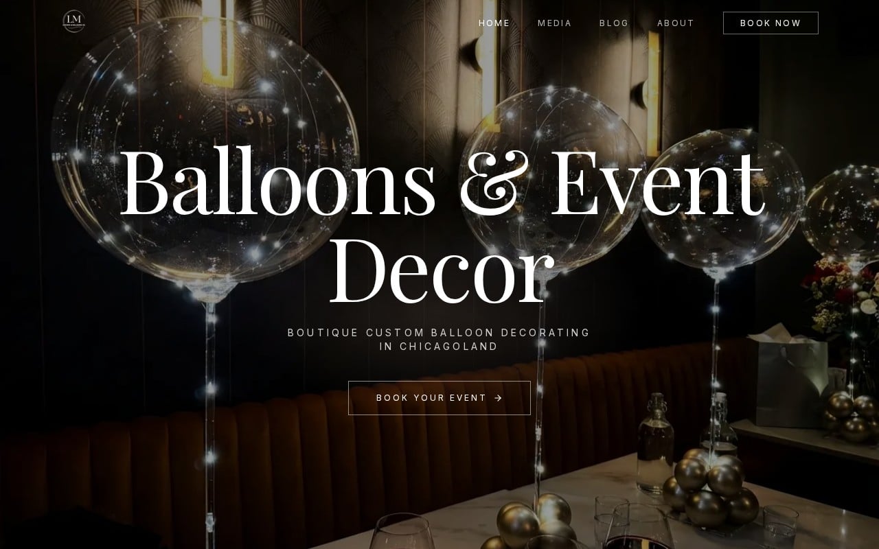 The LM Balloons home page, lit balloons over a restaurant table setting